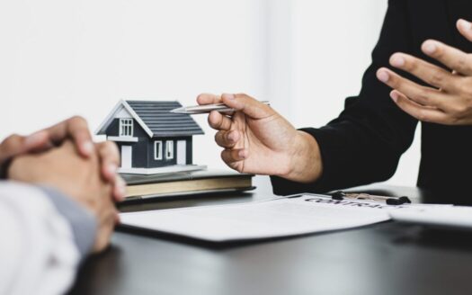 Real estate agent in Greece assisting a client with legal paperwork during a property purchase, showcasing the professional guidance available to buyers.