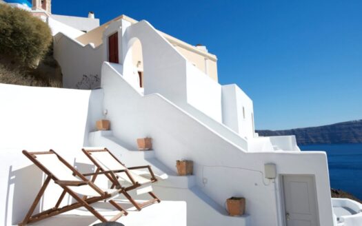 Exterior of a Greek villa with sea views and short-term rental sign representing Greece’s short-term rental regulations and property compliance.