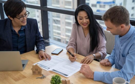 A Greek real estate contract being signed by a buyer and notary, illustrating key steps in the property buying process in Greece.