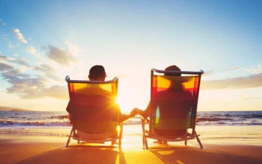 Happy retired couple enjoying seaside lifestyle in Greece, representing affordable retirement living in Greek coastal locations in 2025