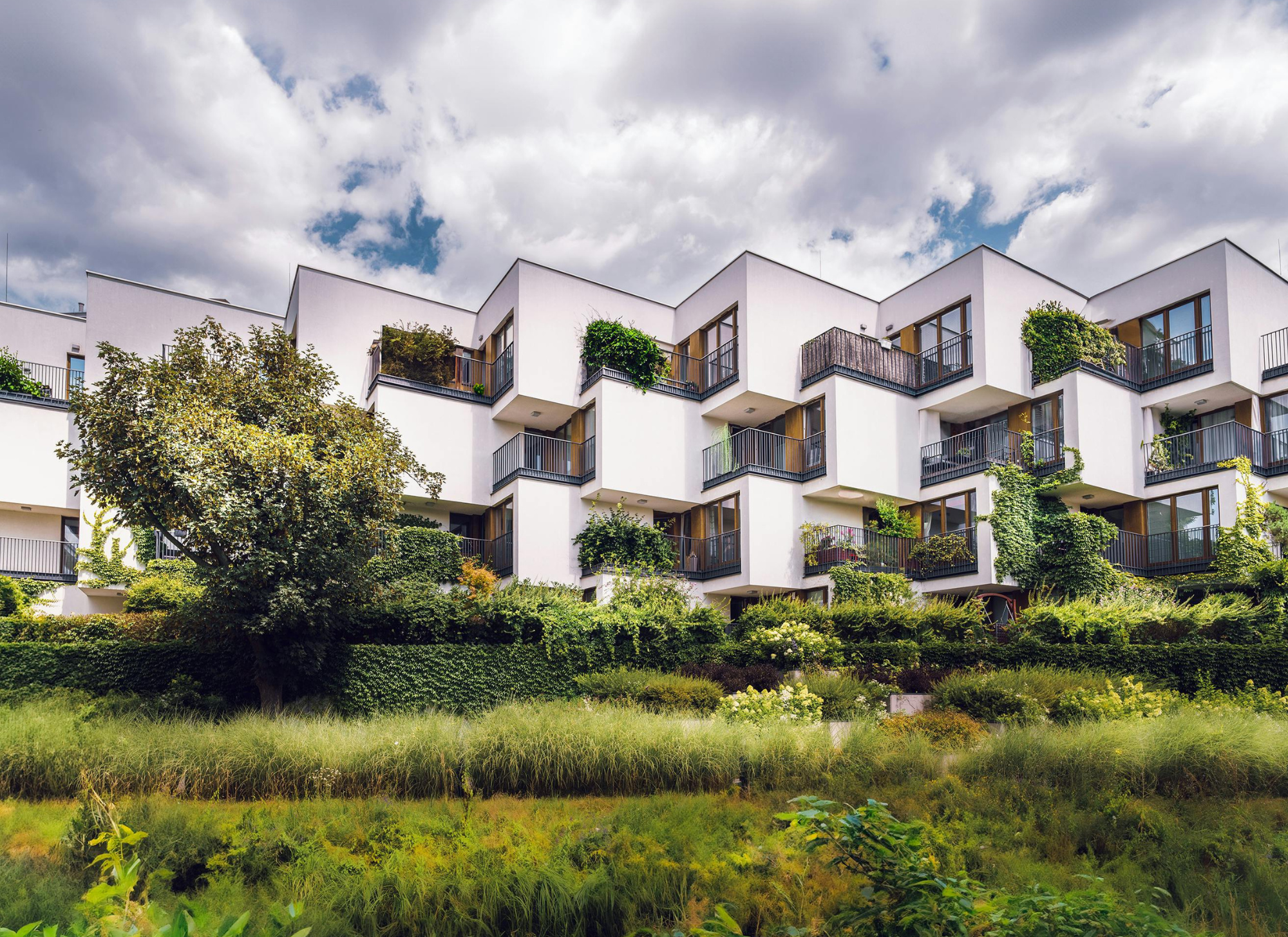 Eco-friendly home with solar panels, sustainable materials, and green landscaping in Greece.