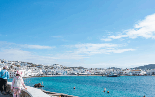Greek coastal town with sea-view houses, popular for second home buyers seeking property investment and lifestyle benefits.