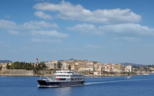 Greek island village with ferry port, homes accessible year-round, property buying guide for Greek islands