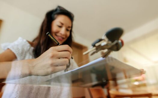 A property owner in Greece reviewing hidden costs, including maintenance, taxes, and insurance, to plan for effective property ownership.