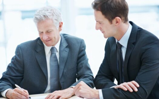 Co-ownership agreement being signed for a property in Greece, with co-owners discussing terms and responsibilities for shared ownership.
