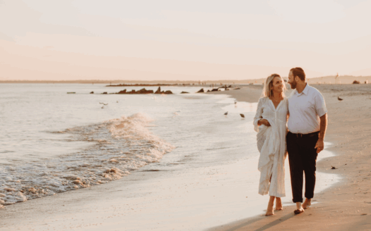 Family walking by a beachfront property in Greece with schools and parks nearby in a peaceful neighbourhood