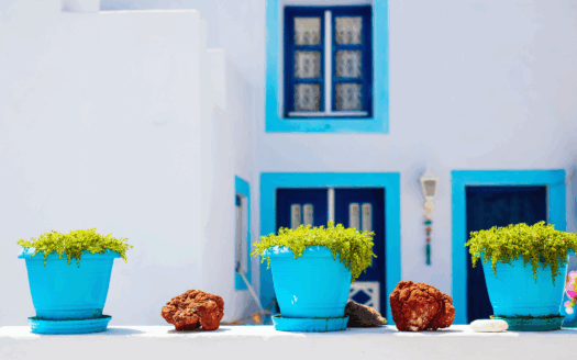 Traditional stone house on a quiet Greek island surrounded by sea and hills, ideal for hidden gem property investment