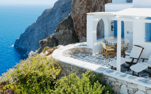Beautiful seaside villa in Greece with panoramic views, showcasing a well-maintained property for sale during peak tourist season, perfect for buyers in 2025.