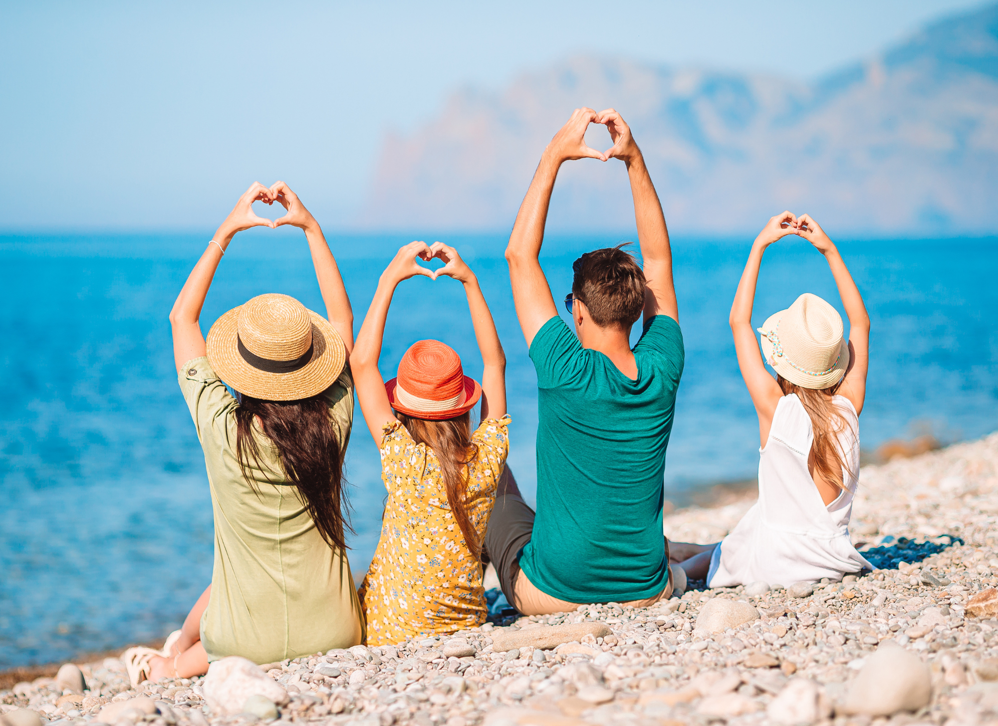 A family enjoying a beachside villa in Corfu, highlighting the ideal location for a family vacation home.
