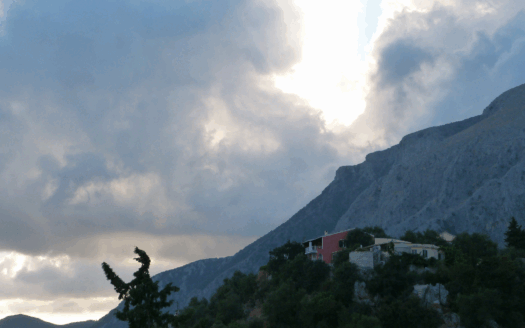 A first-time buyer navigating the Greek property market in Corfu, showcasing a scenic villa and local neighborhood.