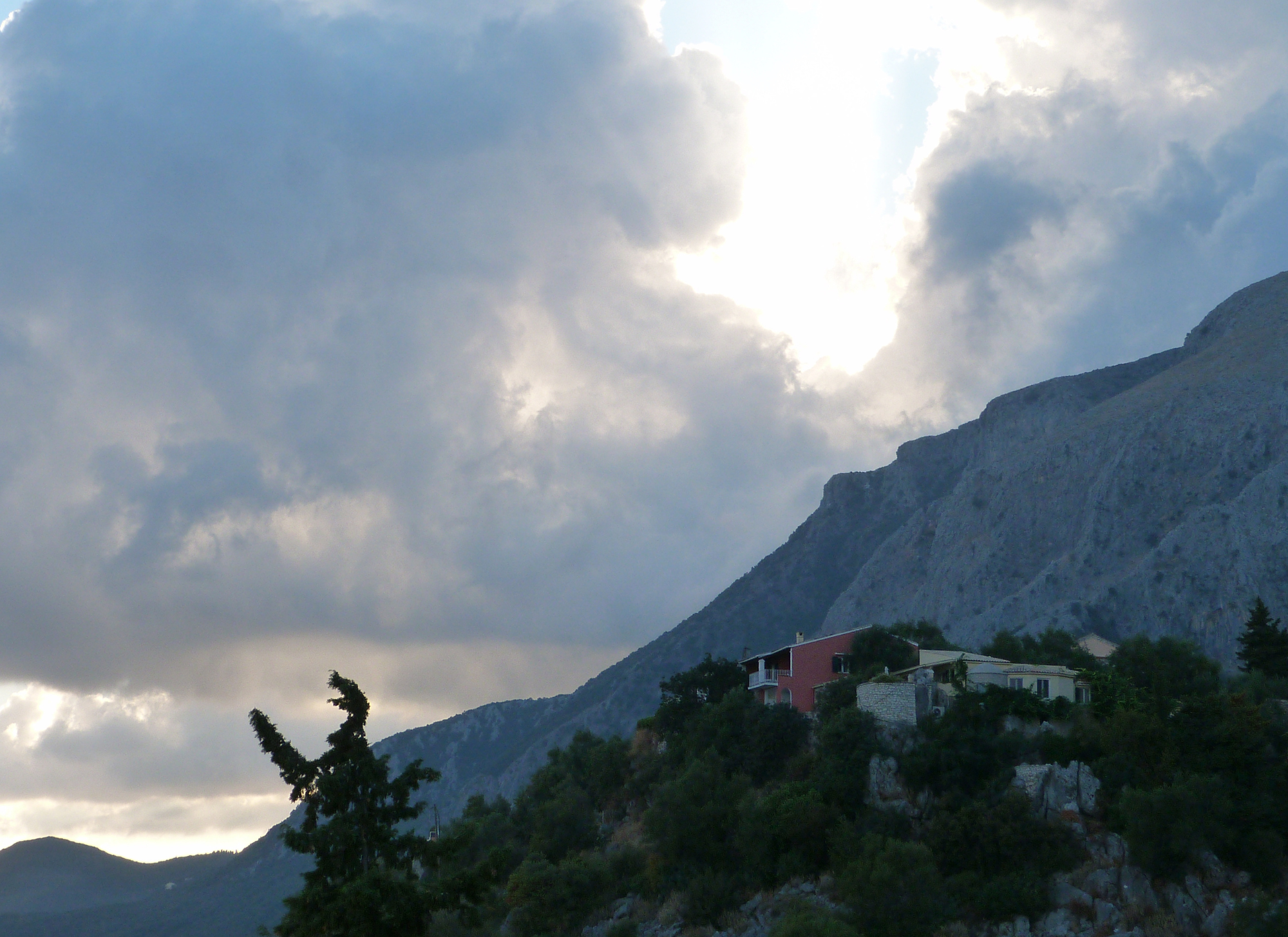 A first-time buyer navigating the Greek property market in Corfu, showcasing a scenic villa and local neighborhood.