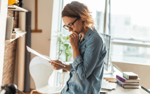 Foreign buyer reviewing documents while purchasing property in Greece, following a clear step-by-step process in 2025.