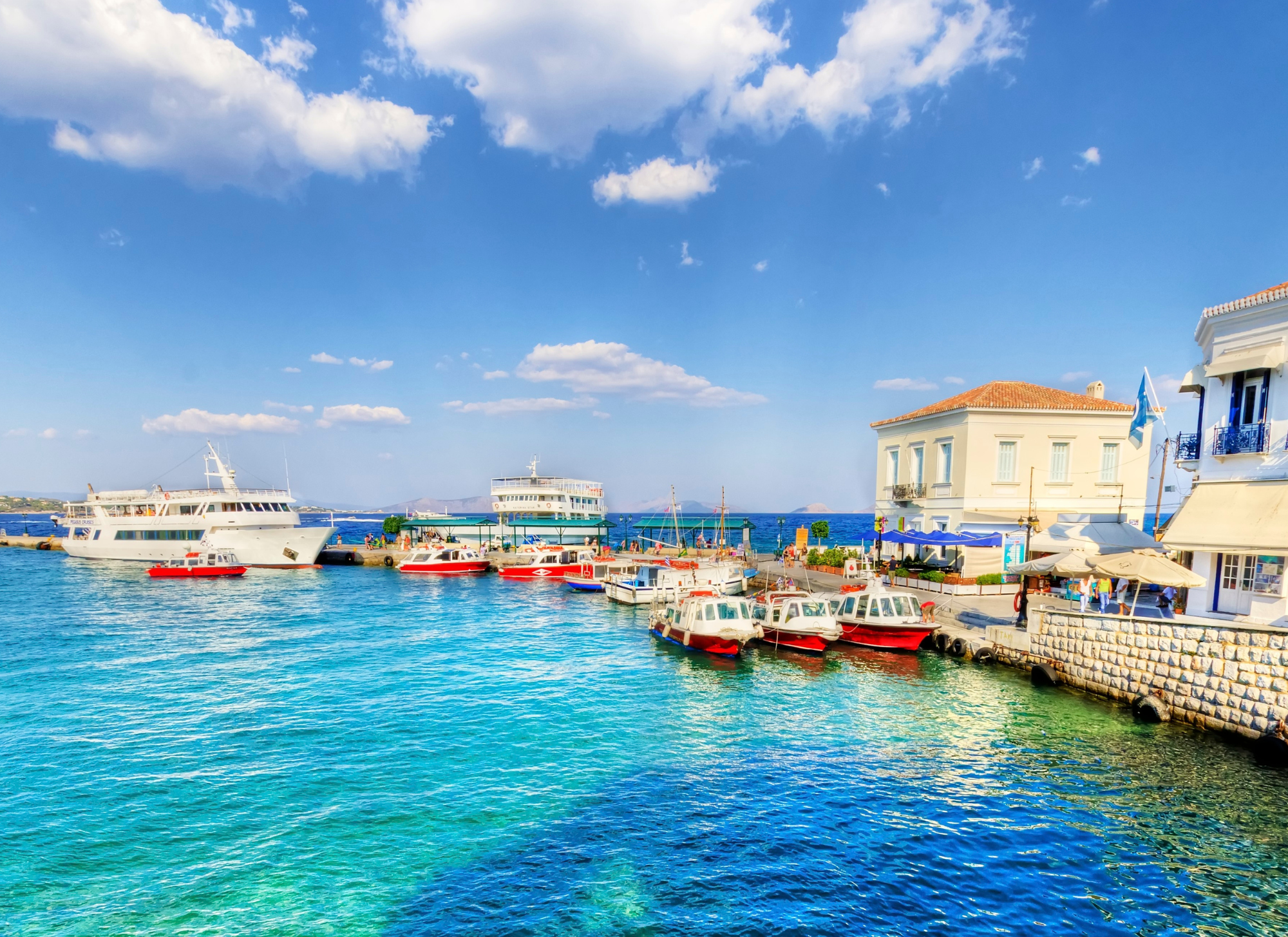 Serene Greek coastal village ideal for retirees buying a home and securing residency in Greece in 2025.