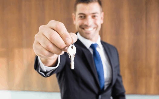 Real estate agent showing Corfu property to a buyer, highlighting key factors in choosing the right agent.