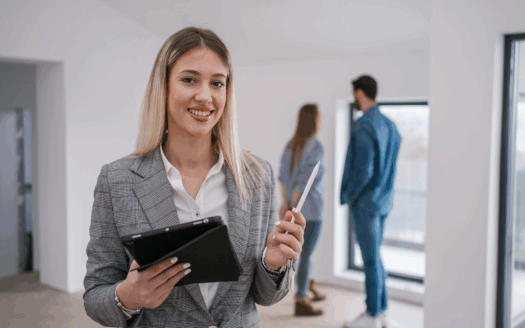 Real estate agent in Greece showing properties to clients, emphasizing key qualities of a good agent.