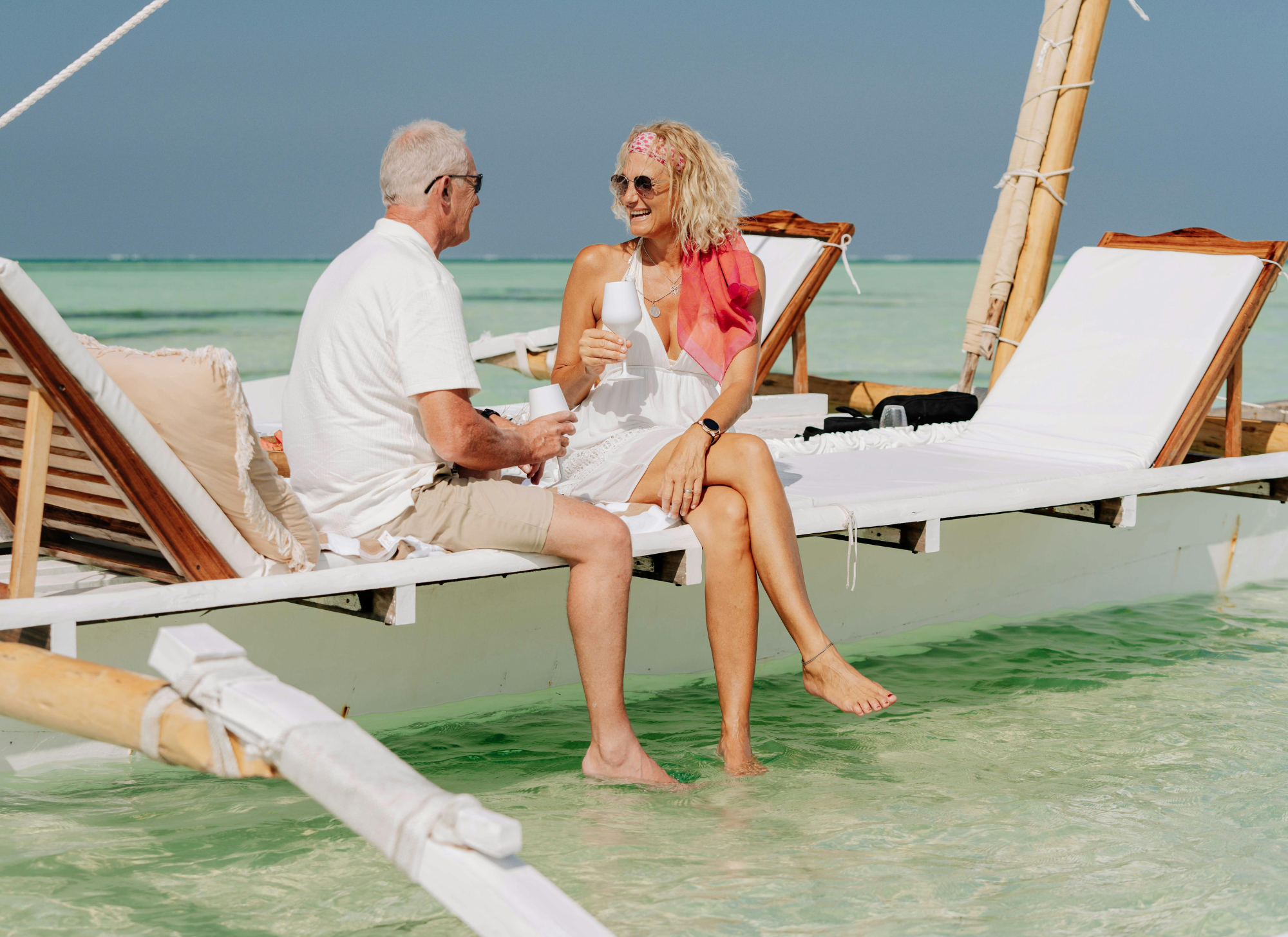 Retired couple enjoying the sea view from their Corfu villa, surrounded by Mediterranean scenery.