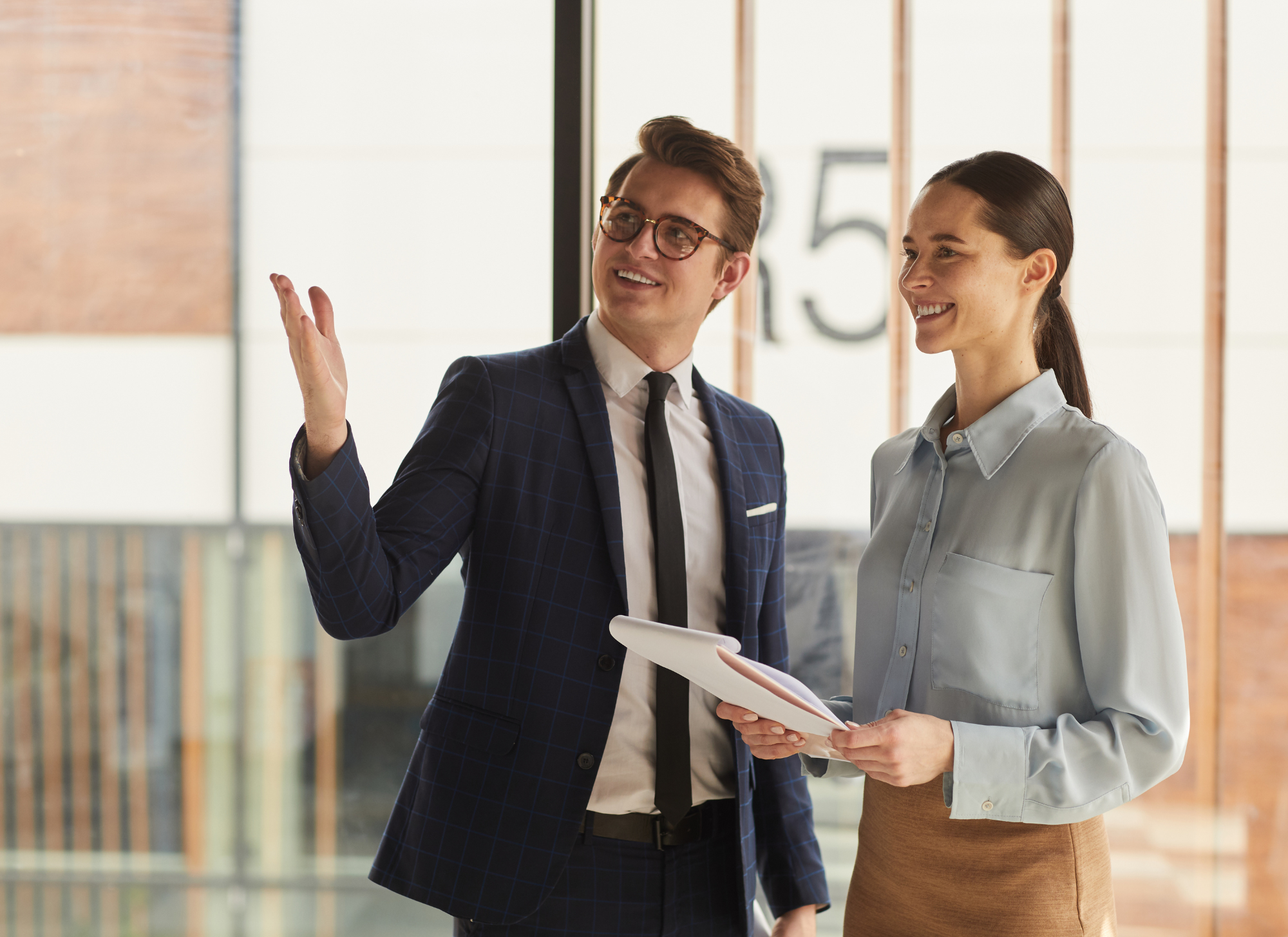 Corfu real estate agent discussing commission fees with clients in a modern office.