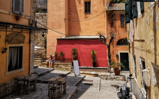 Stone house in Corfu with wooden shutters, ideal for renovation, sea and village views.