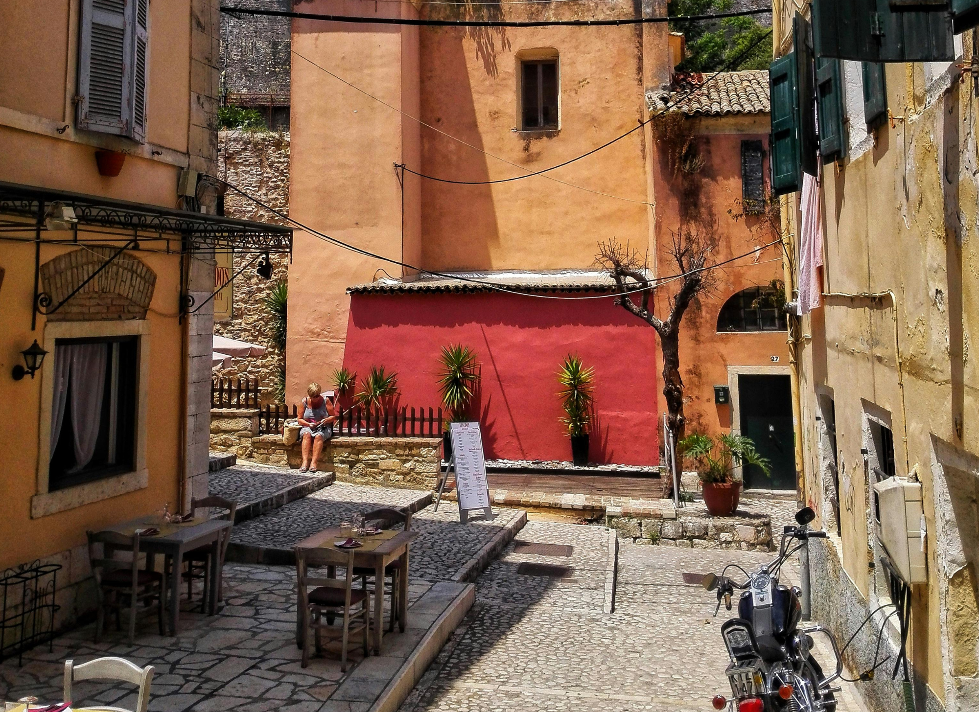 Stone house in Corfu with wooden shutters, ideal for renovation, sea and village views.