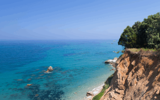 Historic Corfu estate surrounded by lush green hills.