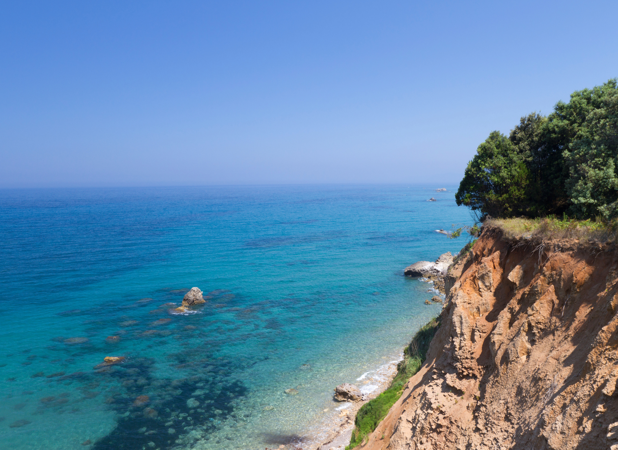 Historic Corfu estate surrounded by lush green hills.