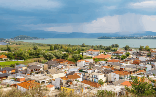 Quiet streets of Perama with local shops and green surroundings.