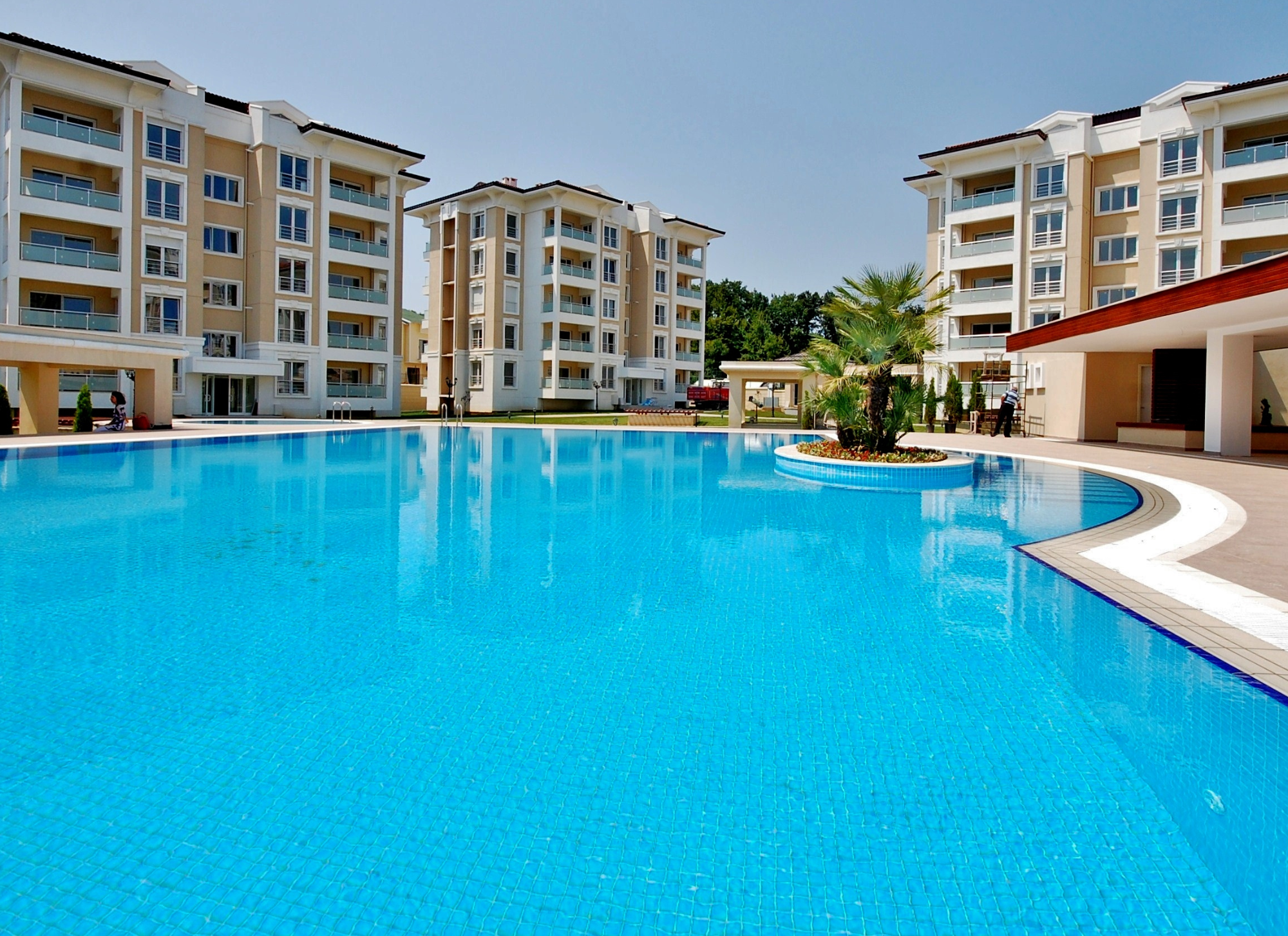 Modern beachfront apartment in Corfu with pool and luxury amenities.