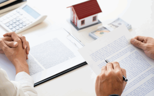 Real estate agent and buyer signing documents for property in Corfu