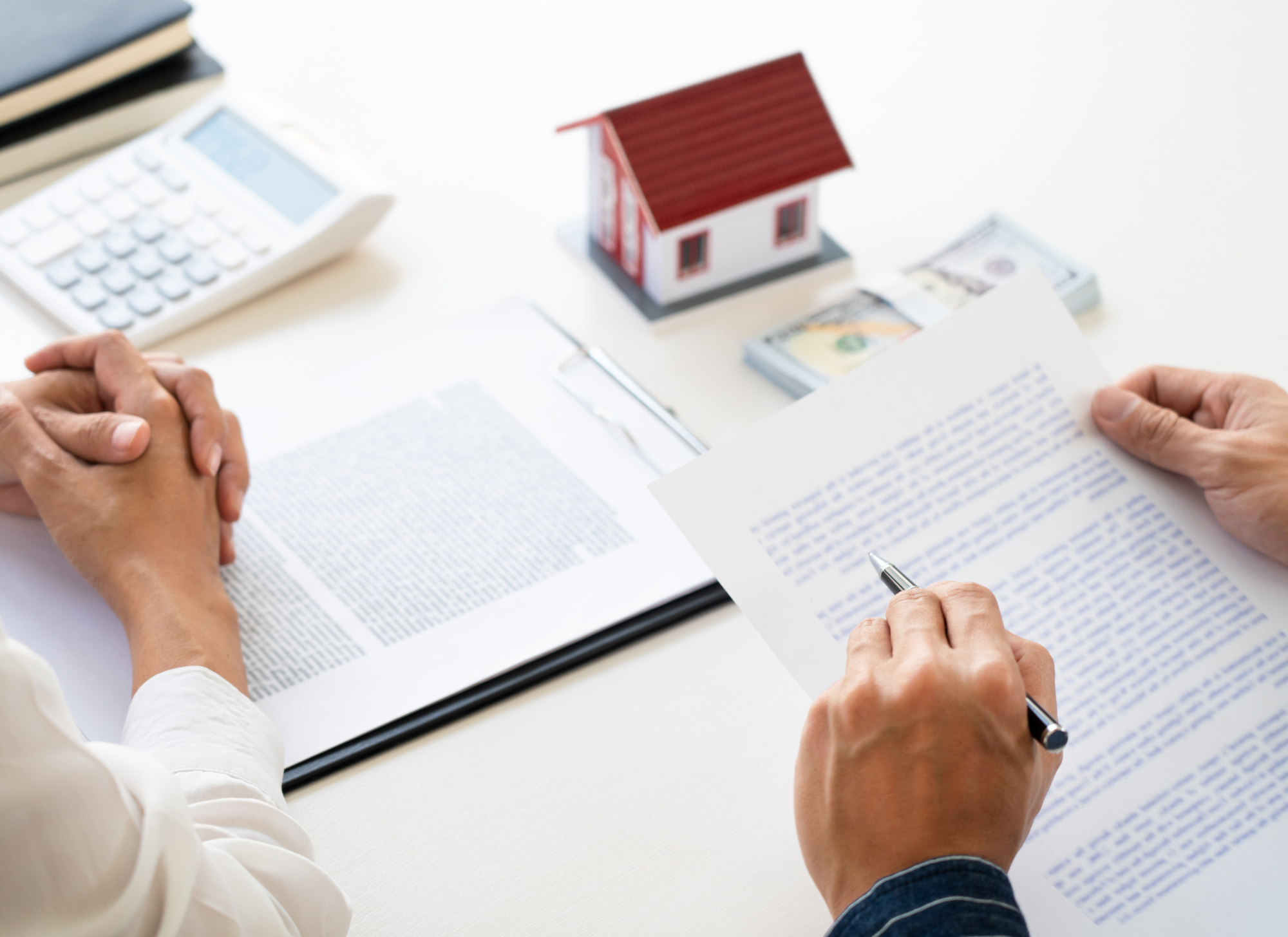 Real estate agent and buyer signing documents for property in Corfu