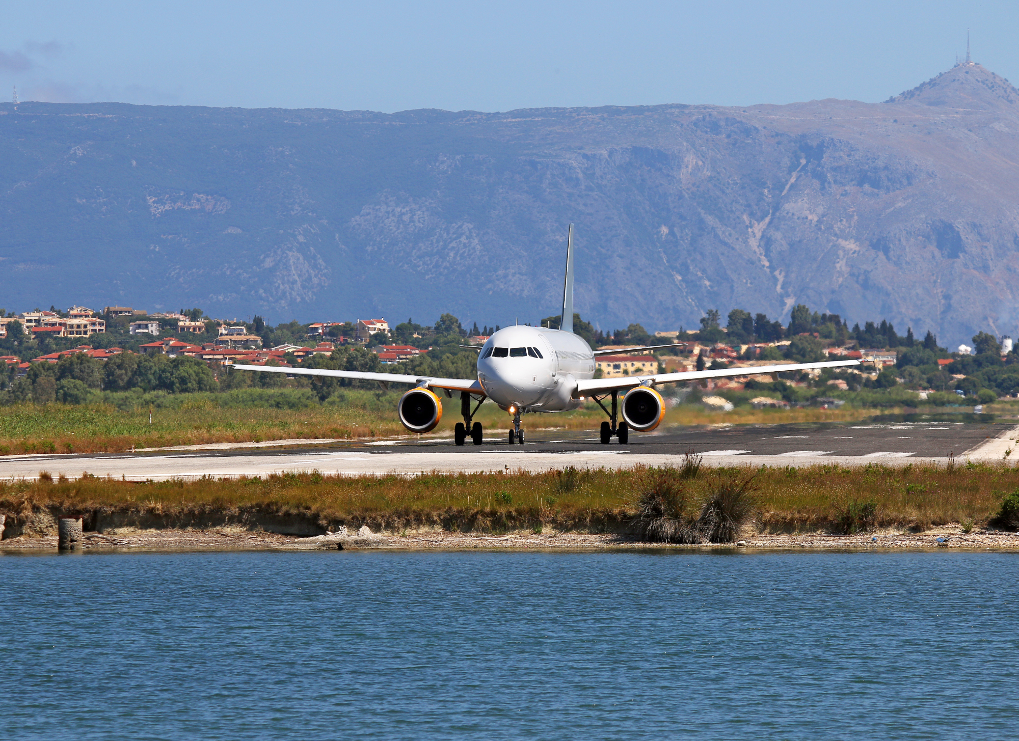 An airplane taking off from the Corfu International Airport runway