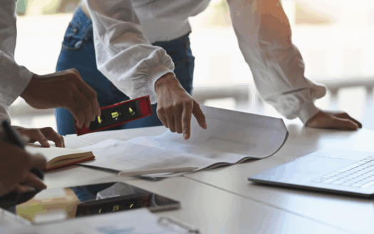 Architect reviewing building plans on a Corfu plot
