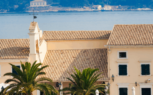 Corfu Town street with shops and people representing population density