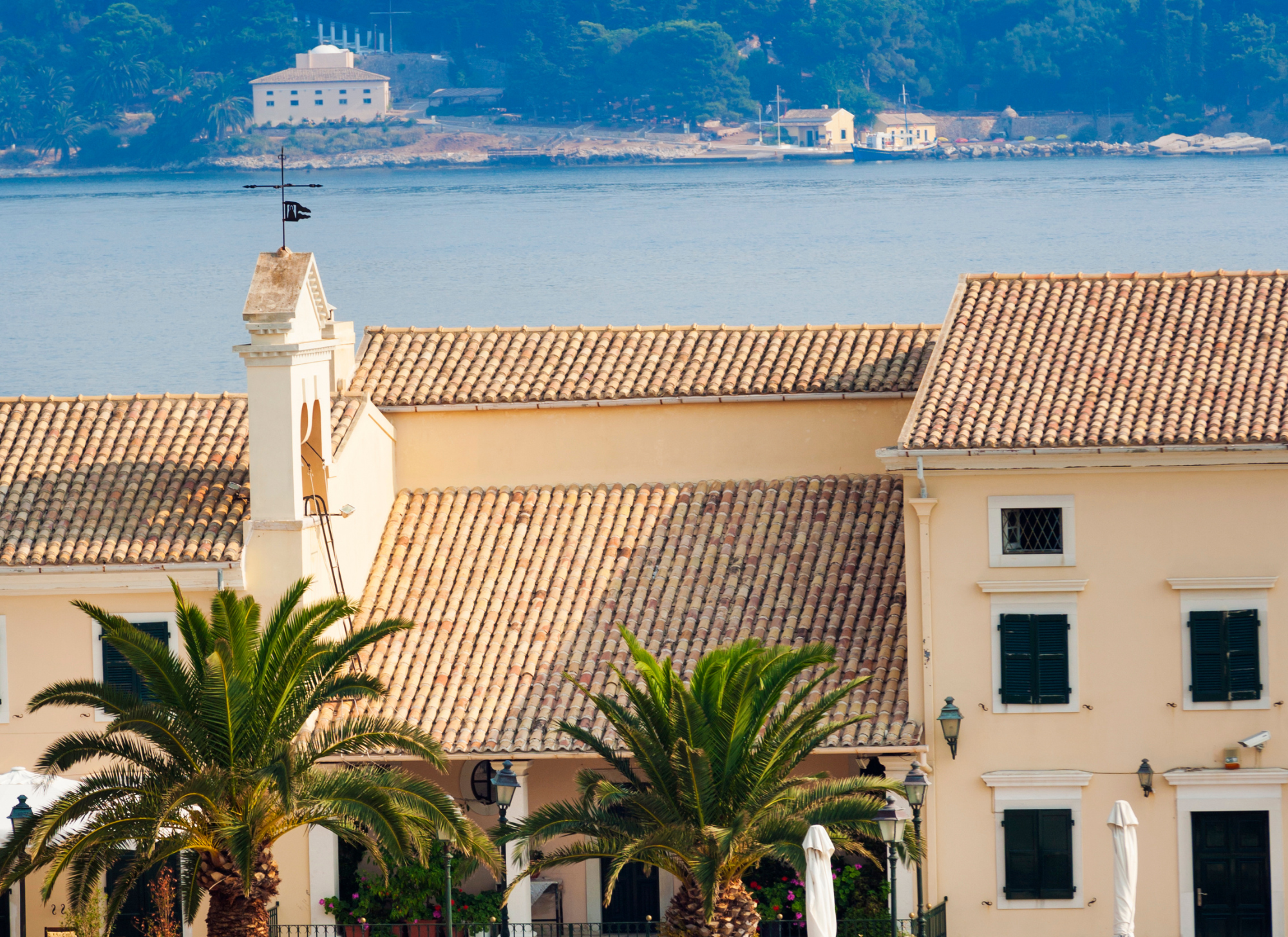 Corfu Town street with shops and people representing population density