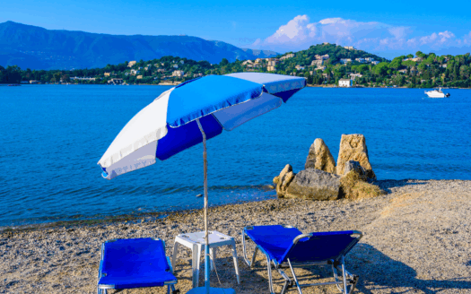 Gouvia Corfu beach with clear blue waters and sunbathers