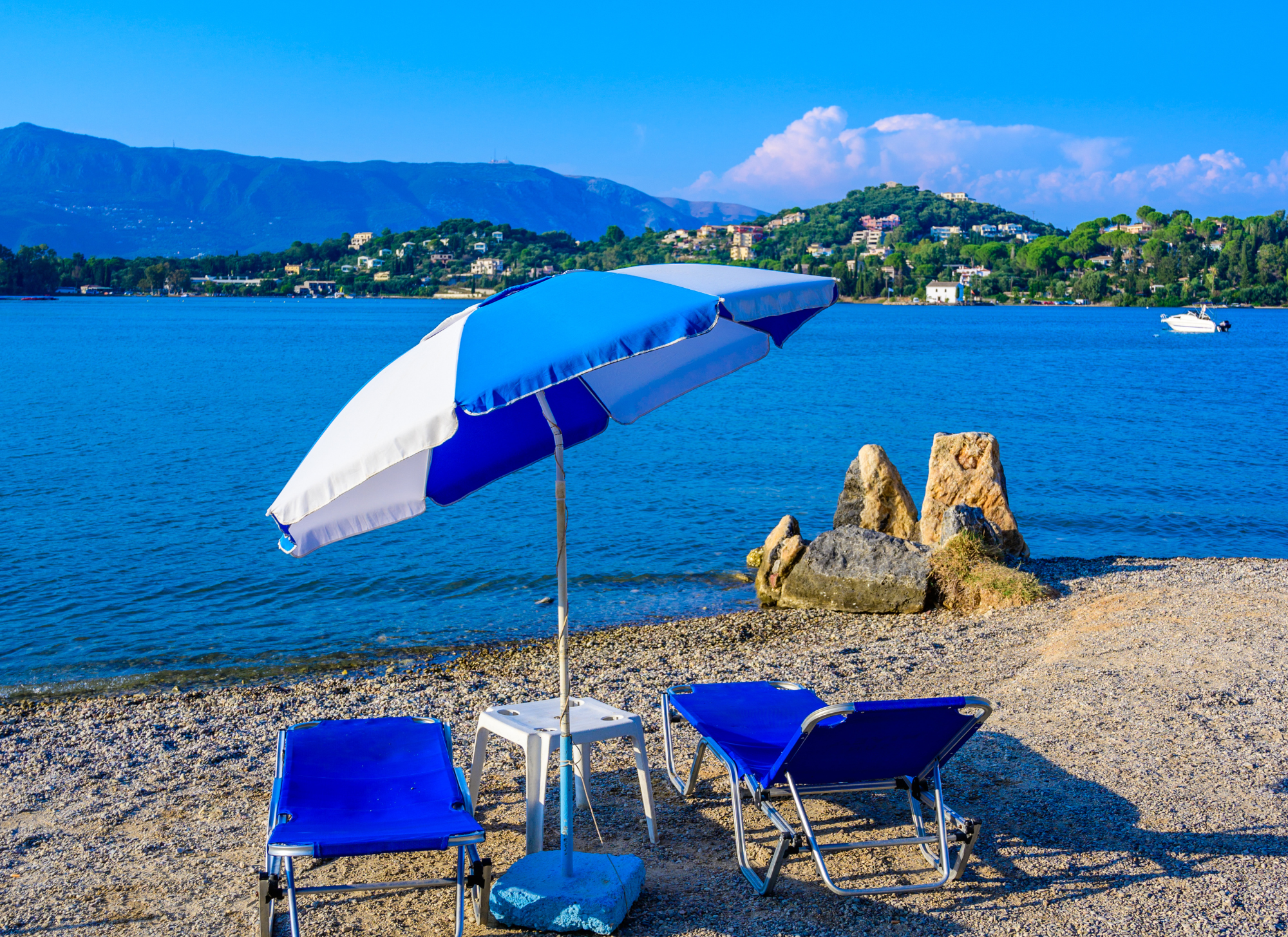 Gouvia Corfu beach with clear blue waters and sunbathers